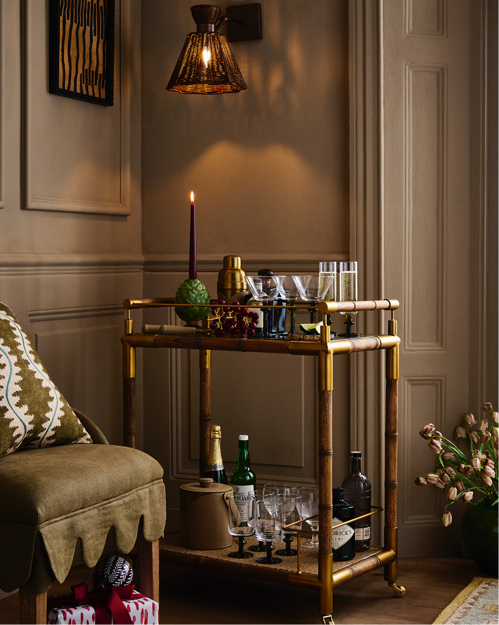 A bar cart laden with drinks and accessories.