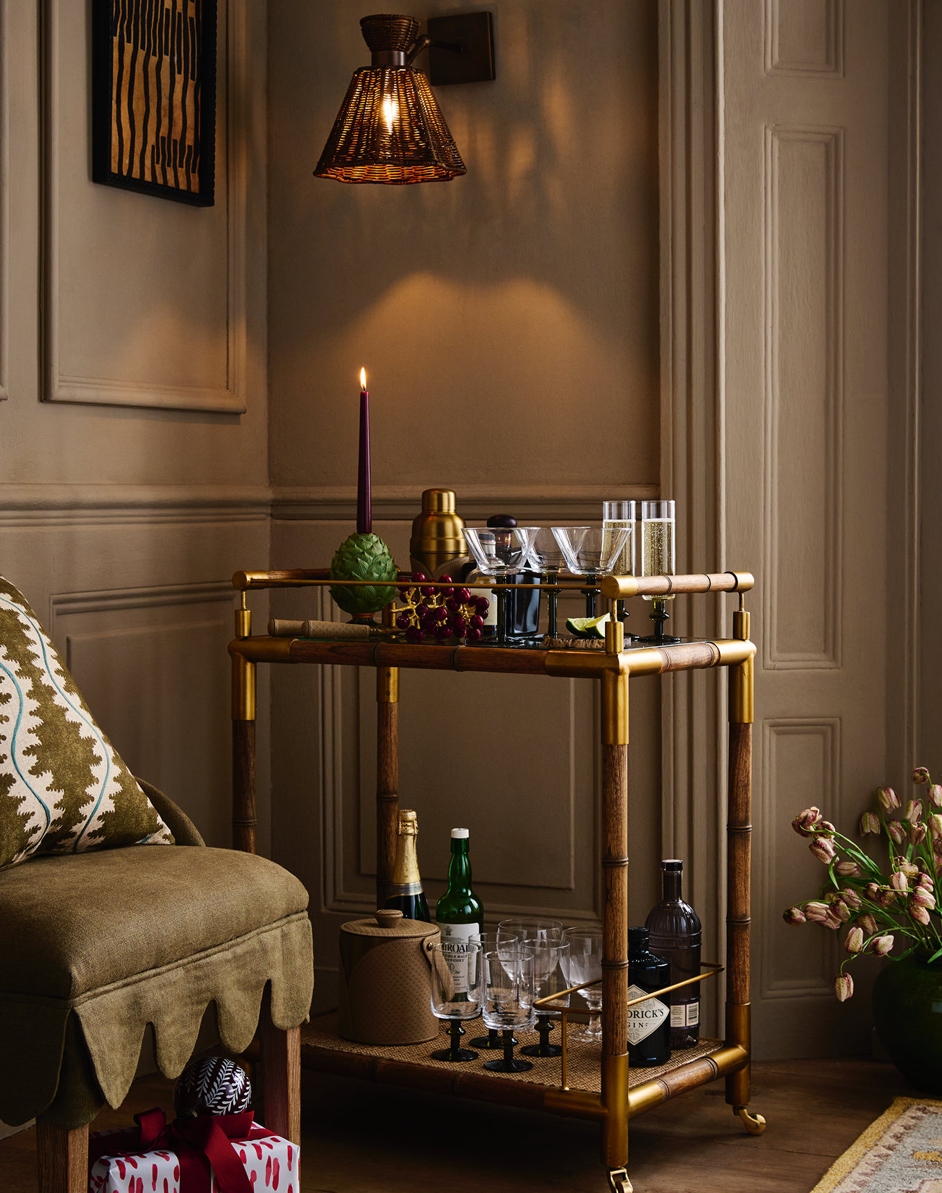 A bar cart laden with drinks and accessories.