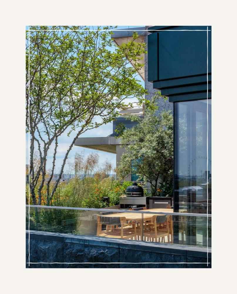 A modern penthouse building with a large terrace
