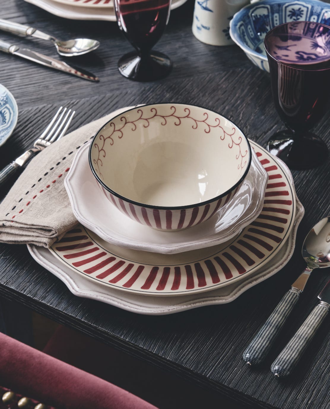 Striped Kintaro tableware on a dark wood table