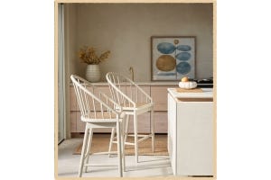 White, wooden bar-stools in a bright and airy kitchen