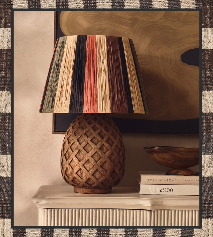 A wooden lamp is decorated with a bright striped lampshade