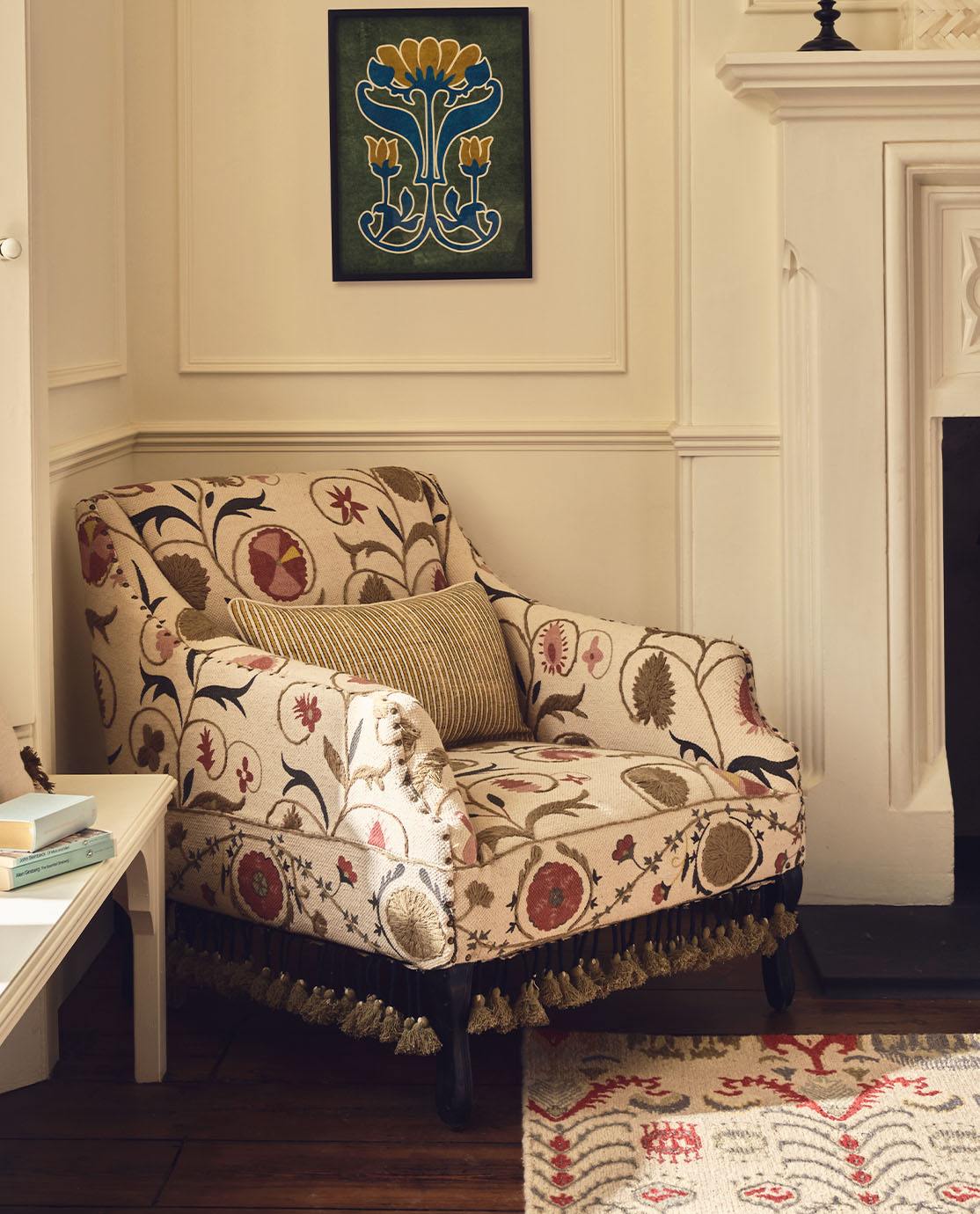 A feather-print armchair decorated with a floral cushion.