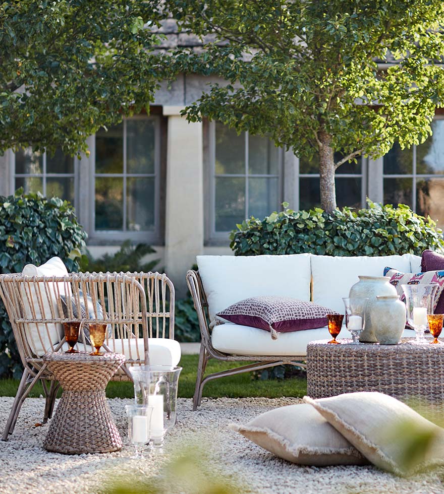 Rattan garden furniture beside a fire pit