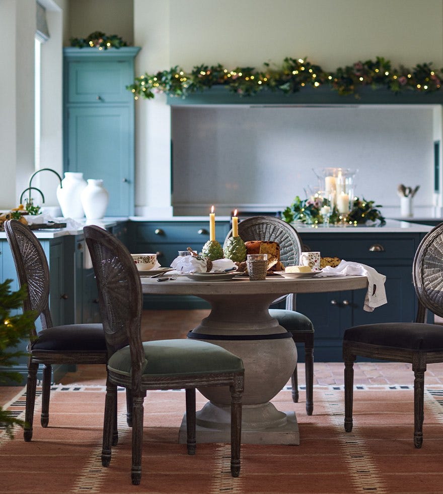 A decorated dining table in a festive kitchen.