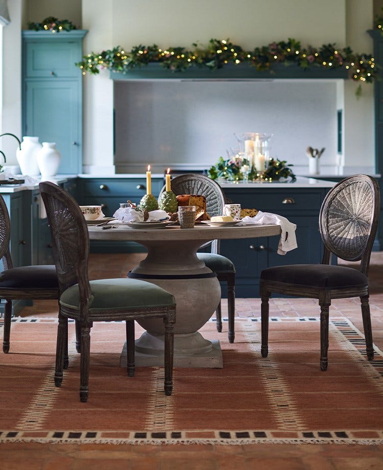 A decorated dining table in a festive kitchen.