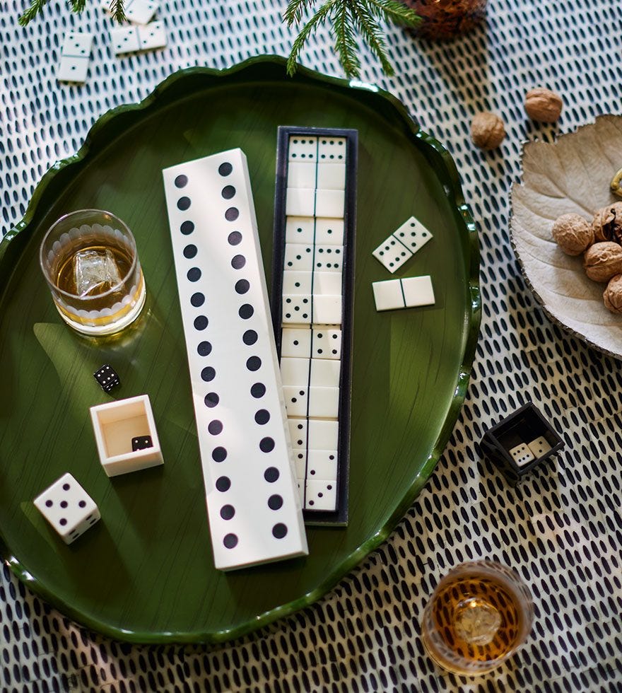 A dominoes gift set on a green tray.