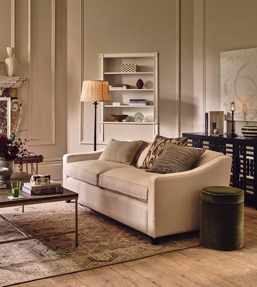 A minimalist-style sitting room with a white sofa, black sideboard and black coffee table