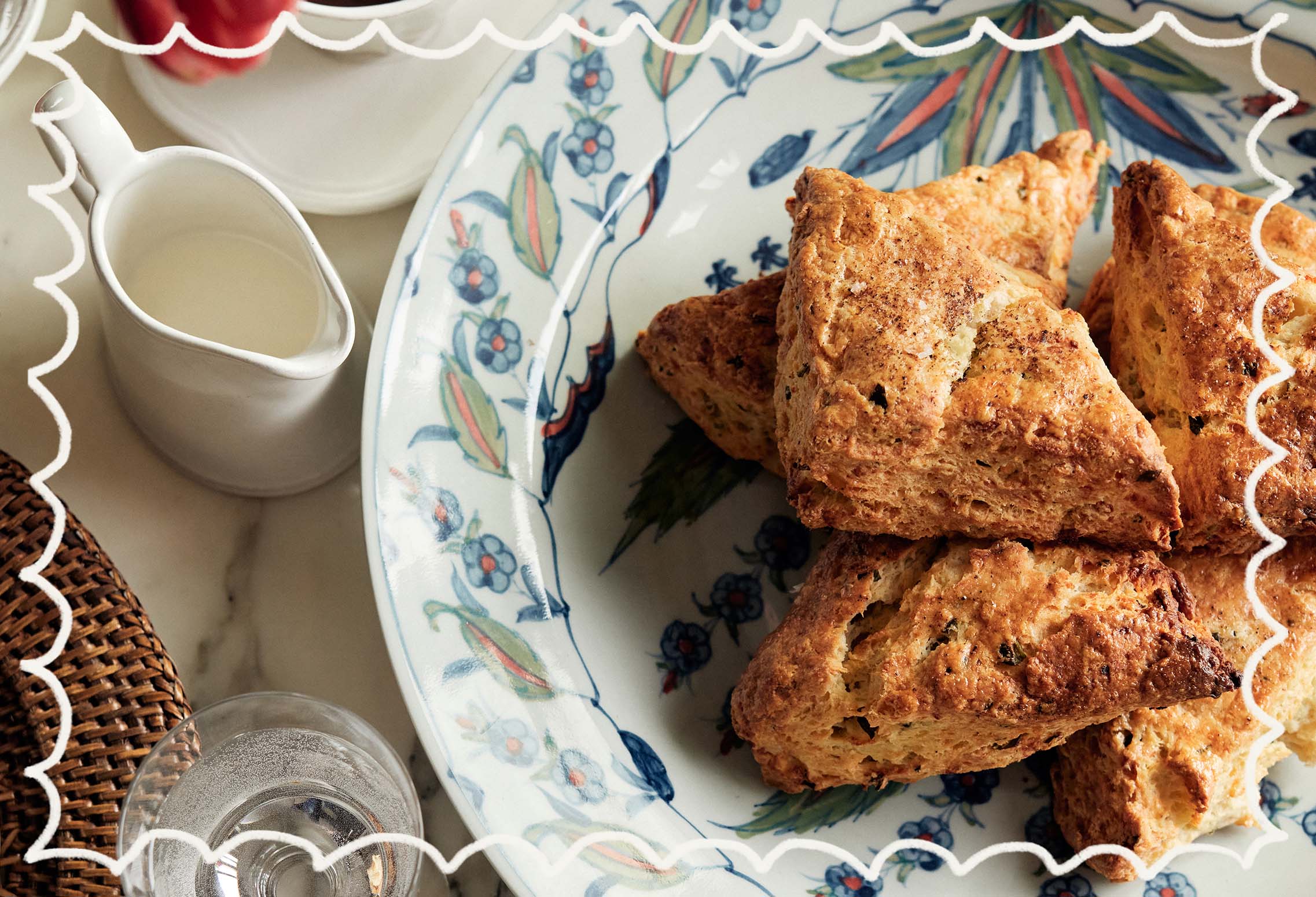 A close-up of Claire's Sour Cream, Chive and Feta scones on a blue and green patterned plate