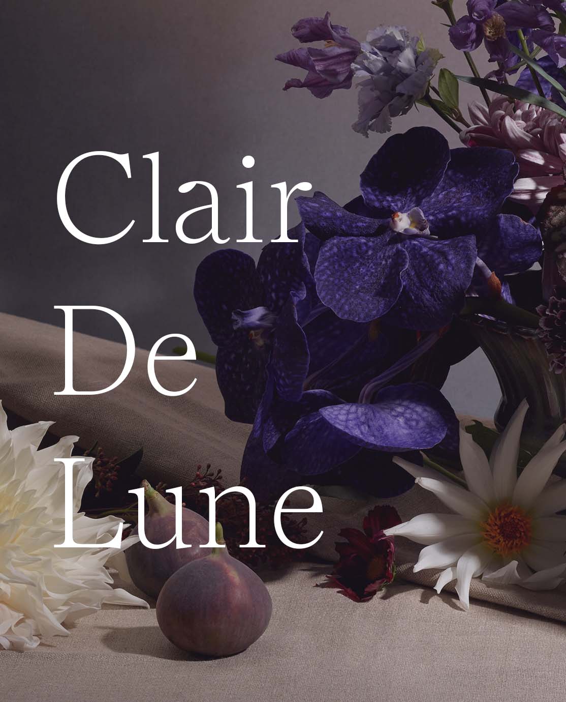 Clair De Lune written in white across a close-up of purple flowers and figs