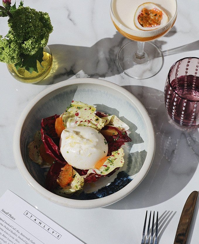 Salad and burrata on a marble table