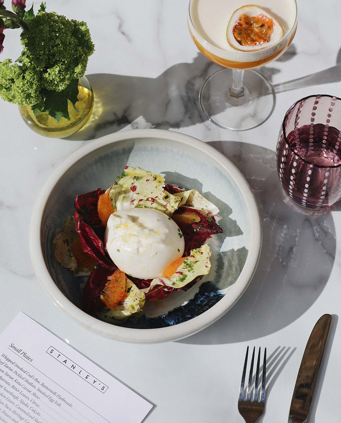 Salad and burrata on a marble table