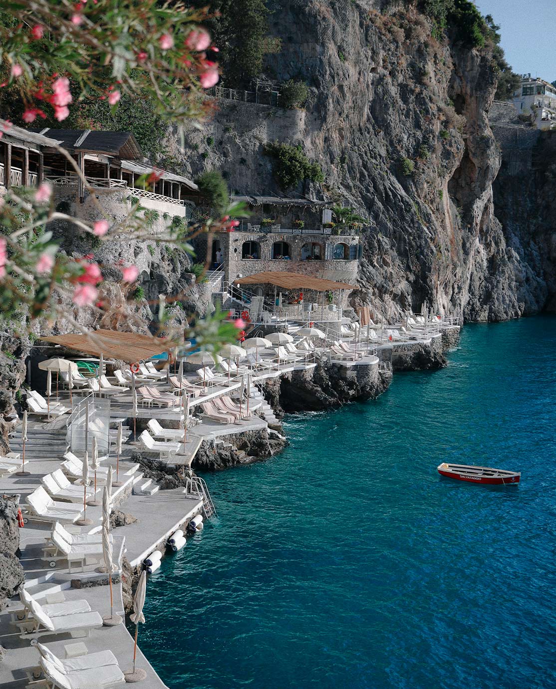 White sunloungers overlooking the Amalfi Coast