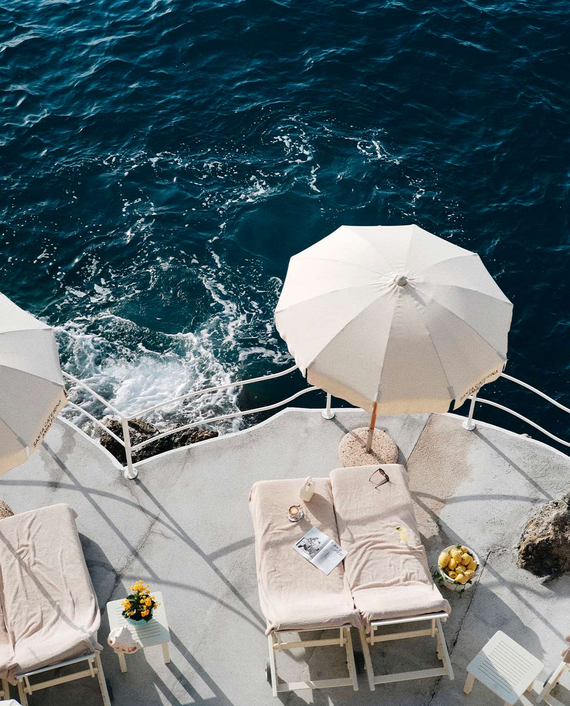 Aerial view of white sunloungers overlooking the Amalfi Coast