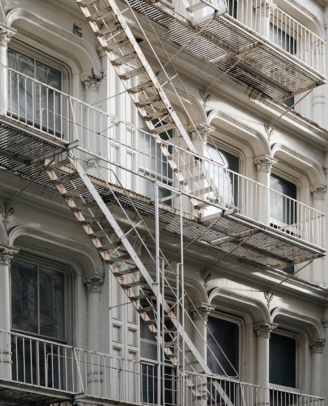 White facade and fire escape stairs in New York