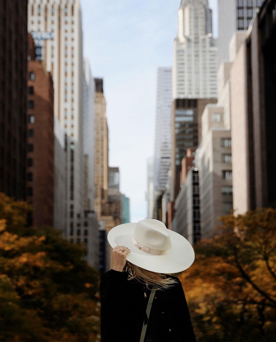 Woman wearing a white hat in an autumnal Central Park