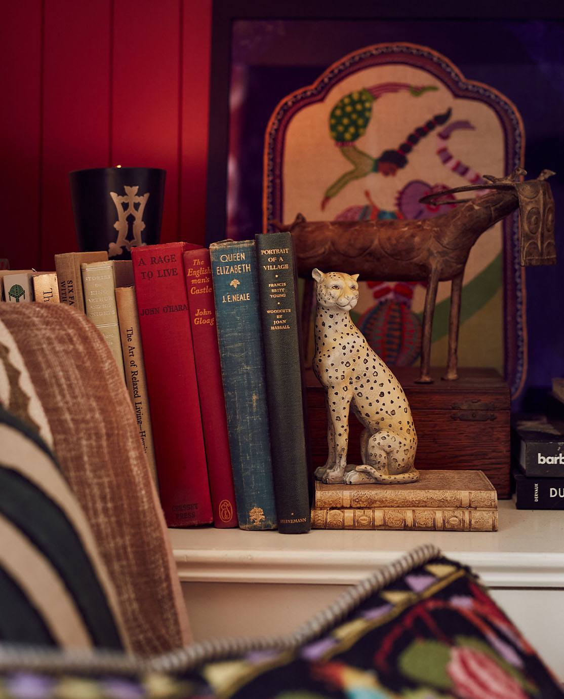 OKA's leopard Lakadema bookend supporting a selection of antique books