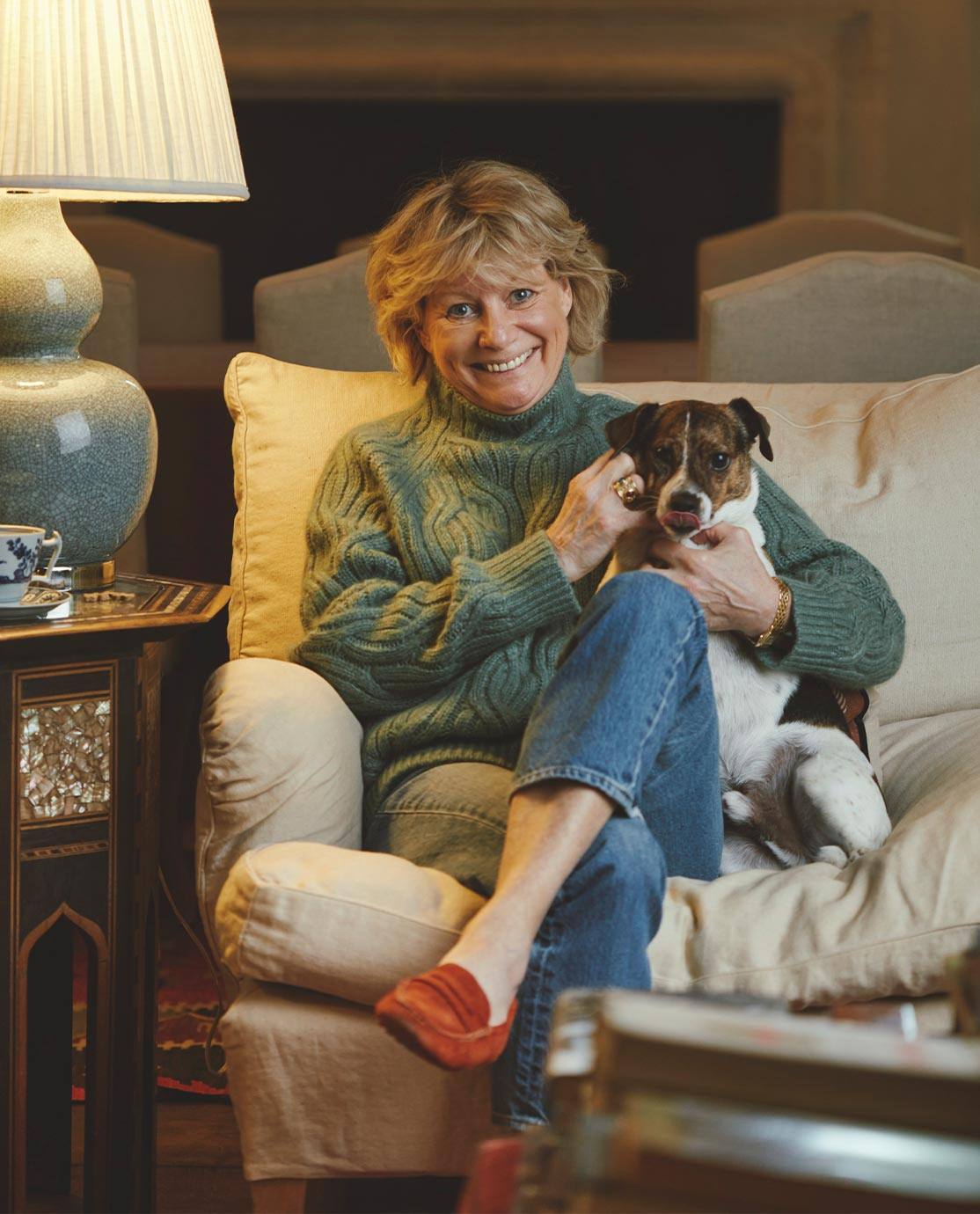 Sue Jones and her Jack Russell sat on a white sofa