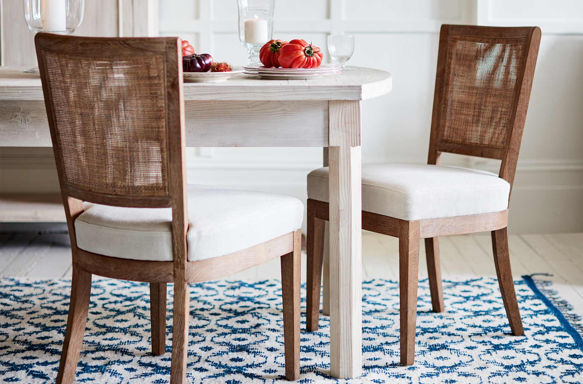 Rattan dining chairs with white linen seats