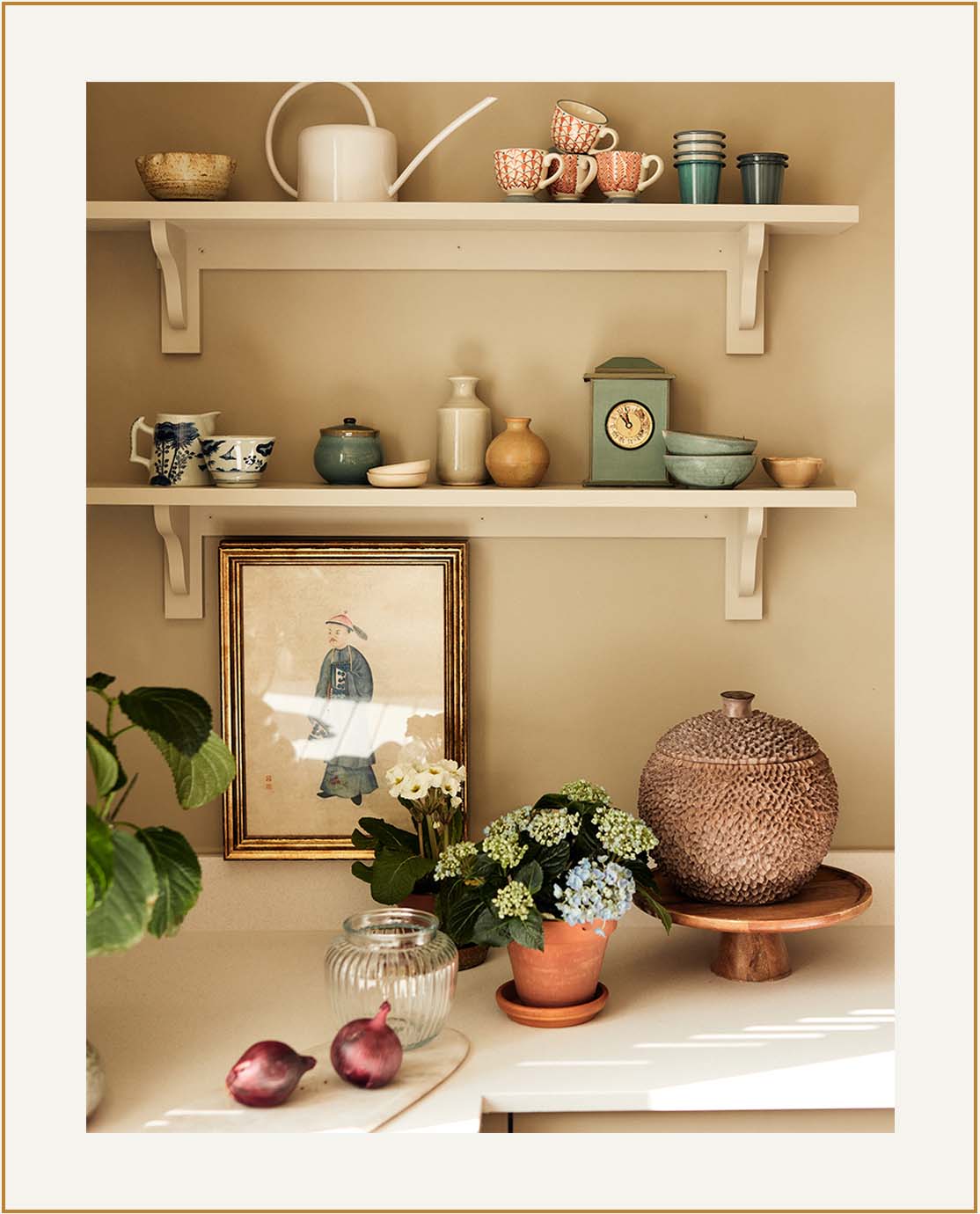 A light kitchen corner, with white shelves and red and blue accessories