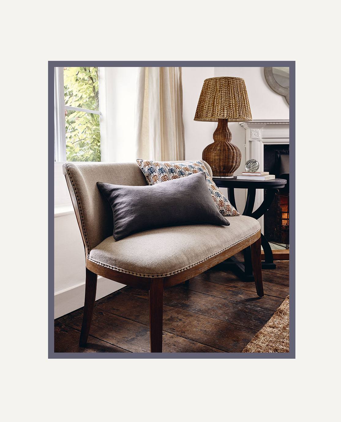 A linen-upholstered bench decorated with cushions