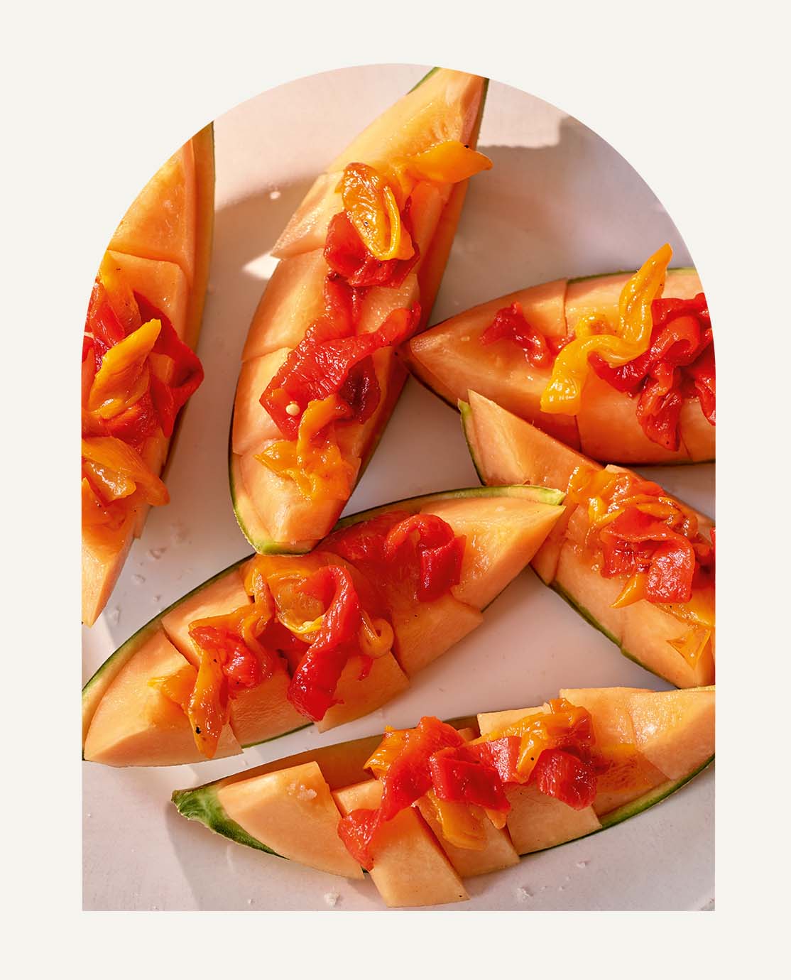 Slices of melon decorated with pickled peppers